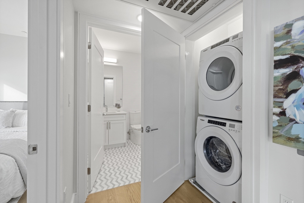 301 Border Street, Unit 611 Boston, MA 02128 - Photo 16 of 32 a view of a hallway with washer and dryer