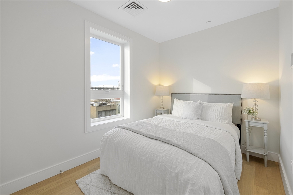 301 Border Street, Unit 611 Boston, MA 02128 - Photo 18 of 32 a bedroom with a bed and a window