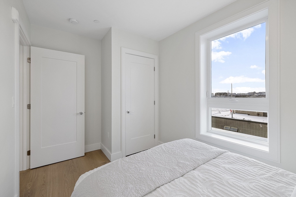 301 Border Street, Unit 611 Boston, MA 02128 - Photo 19 of 32 a bedroom with a bed and a window