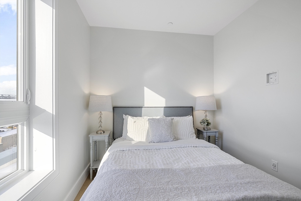 301 Border Street, Unit 611 Boston, MA 02128 - Photo 20 of 32 a bedroom with a bed and a large window