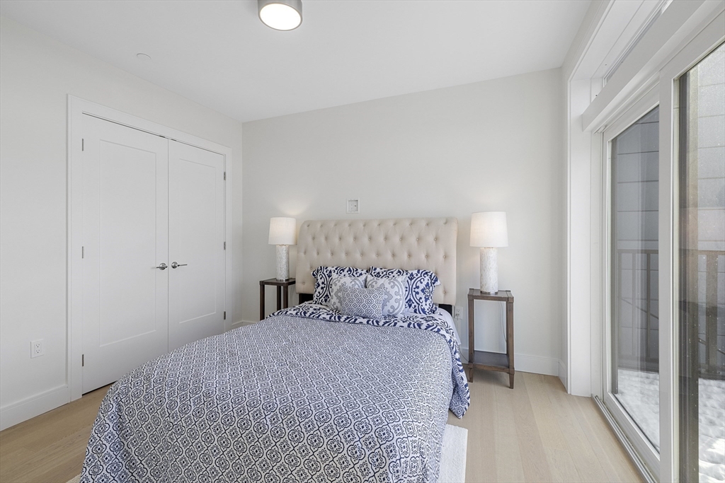 301 Border Street, Unit 611 Boston, MA 02128 - Photo 2 of 32 a bedroom with a bed and a window