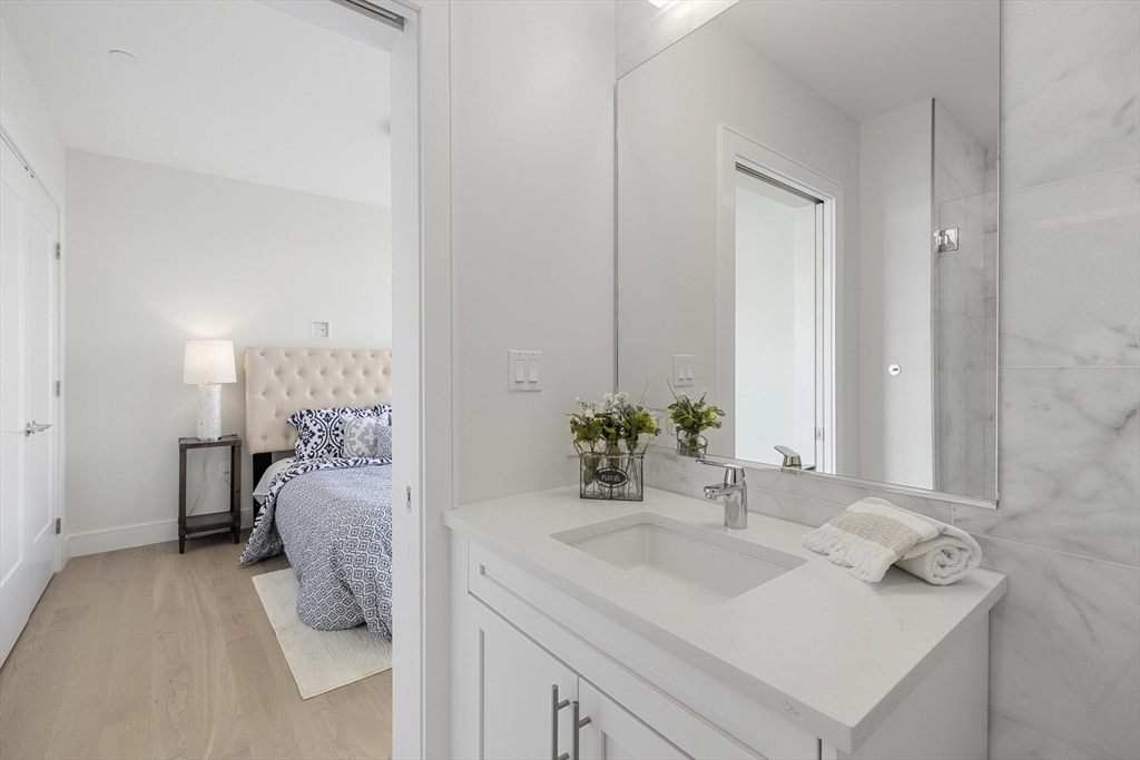 301 Border Street, Unit 611 Boston, MA 02128 - Photo 5 of 32 a en suite bathroom with a sink and a mirror