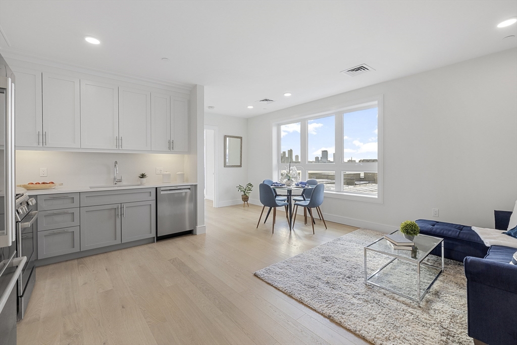 301 Border Street, Unit 611 Boston, MA 02128 - Photo 7 of 32 a kitchen with a sink a counter top space and appliances