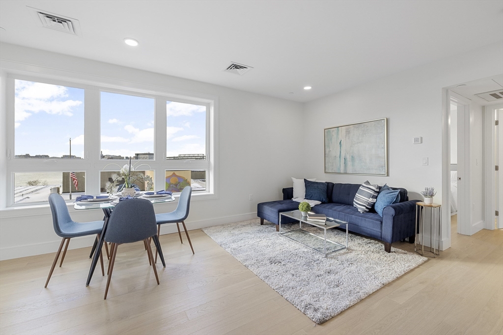 301 Border Street, Unit 611 Boston, MA 02128 - Photo 8 of 32 a living room with furniture and a large window