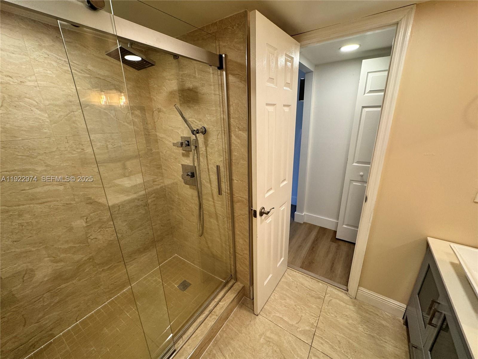 7928 West Drive, Unit 602 North Bay Village, FL 33141 - Photo 17 of 44 a bathroom with a shower and a glass door