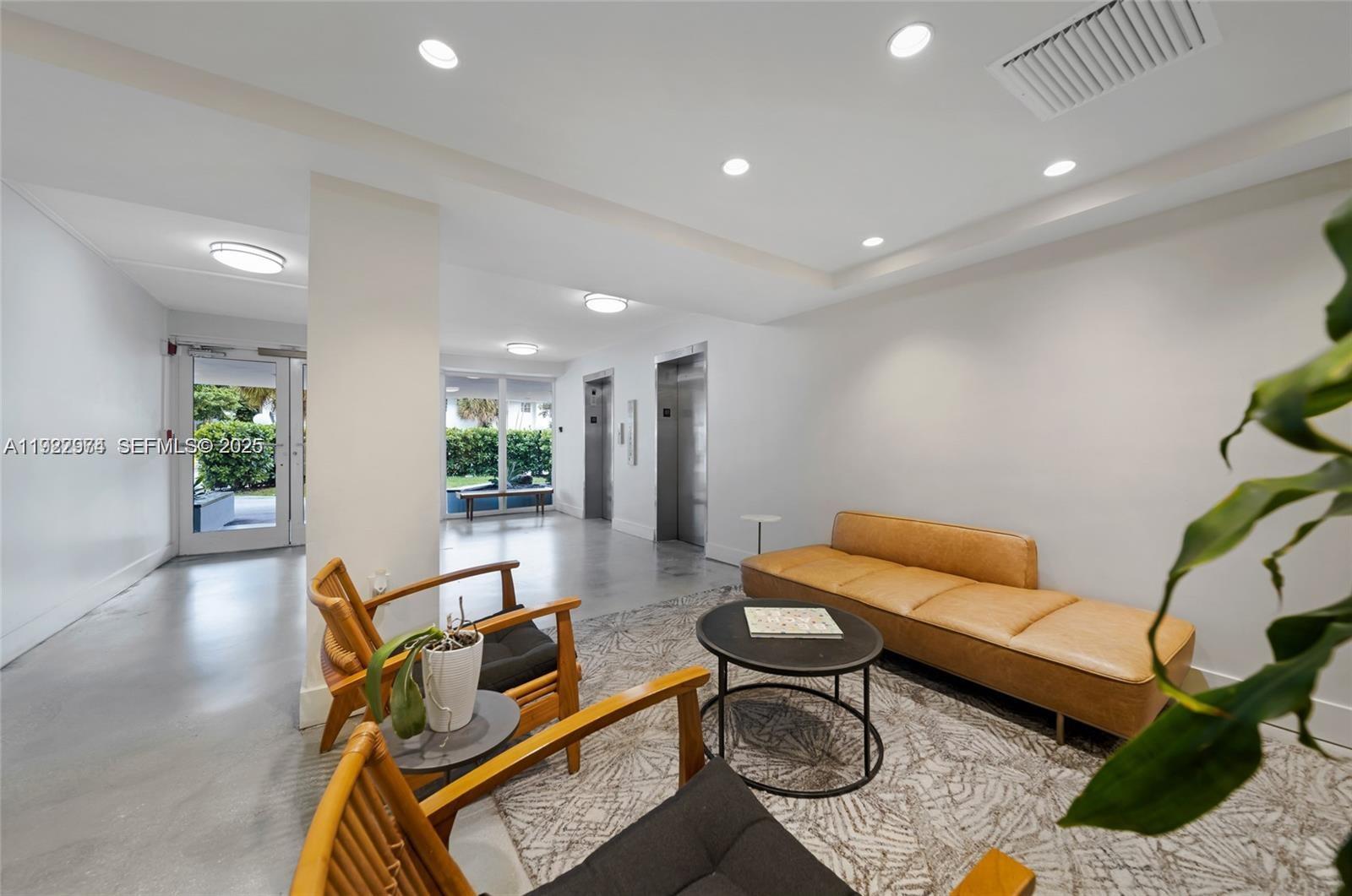 7928 West Drive, Unit 602 North Bay Village, FL 33141 - Photo 24 of 44 a living room with furniture a rug and a potted plant