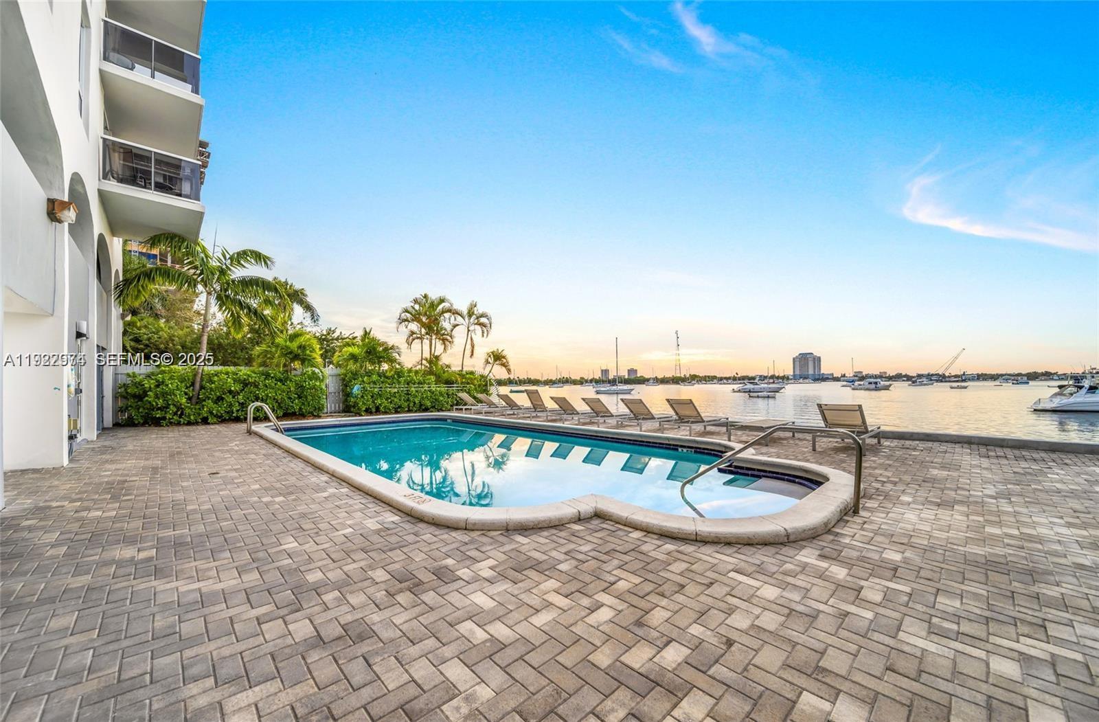 7928 West Drive, Unit 602 North Bay Village, FL 33141 - Photo 30 of 44 a view of a swimming pool with a terrace