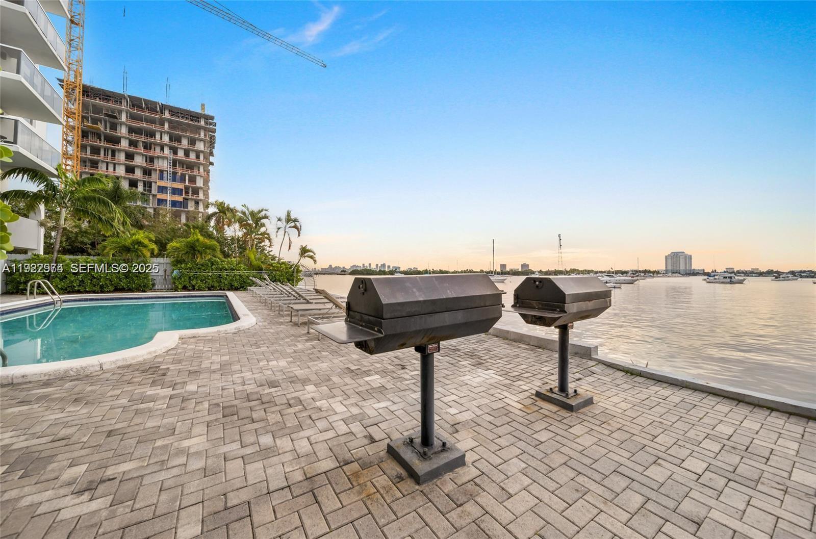 7928 West Drive, Unit 602 North Bay Village, FL 33141 - Photo 32 of 44 a view of swimming pool with a yard and lake view
