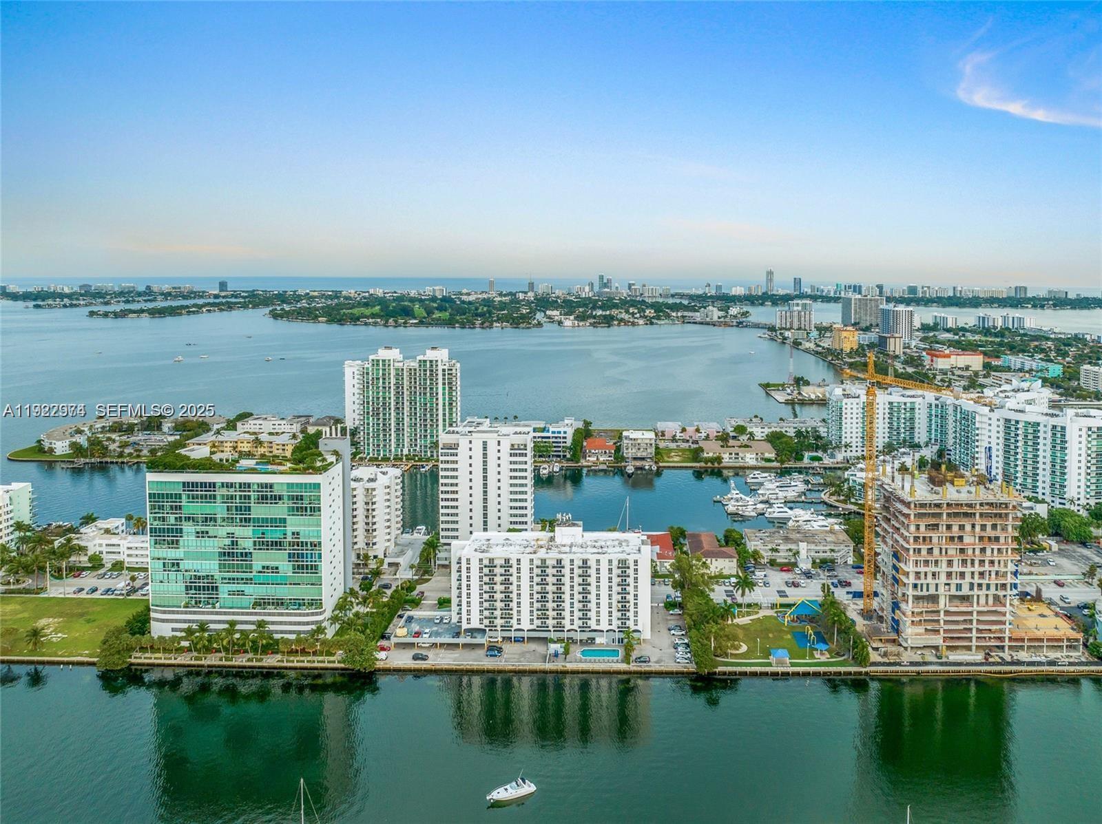 7928 West Drive, Unit 602 North Bay Village, FL 33141 - Photo 38 of 44 a view of a lake with boats and trees in the background