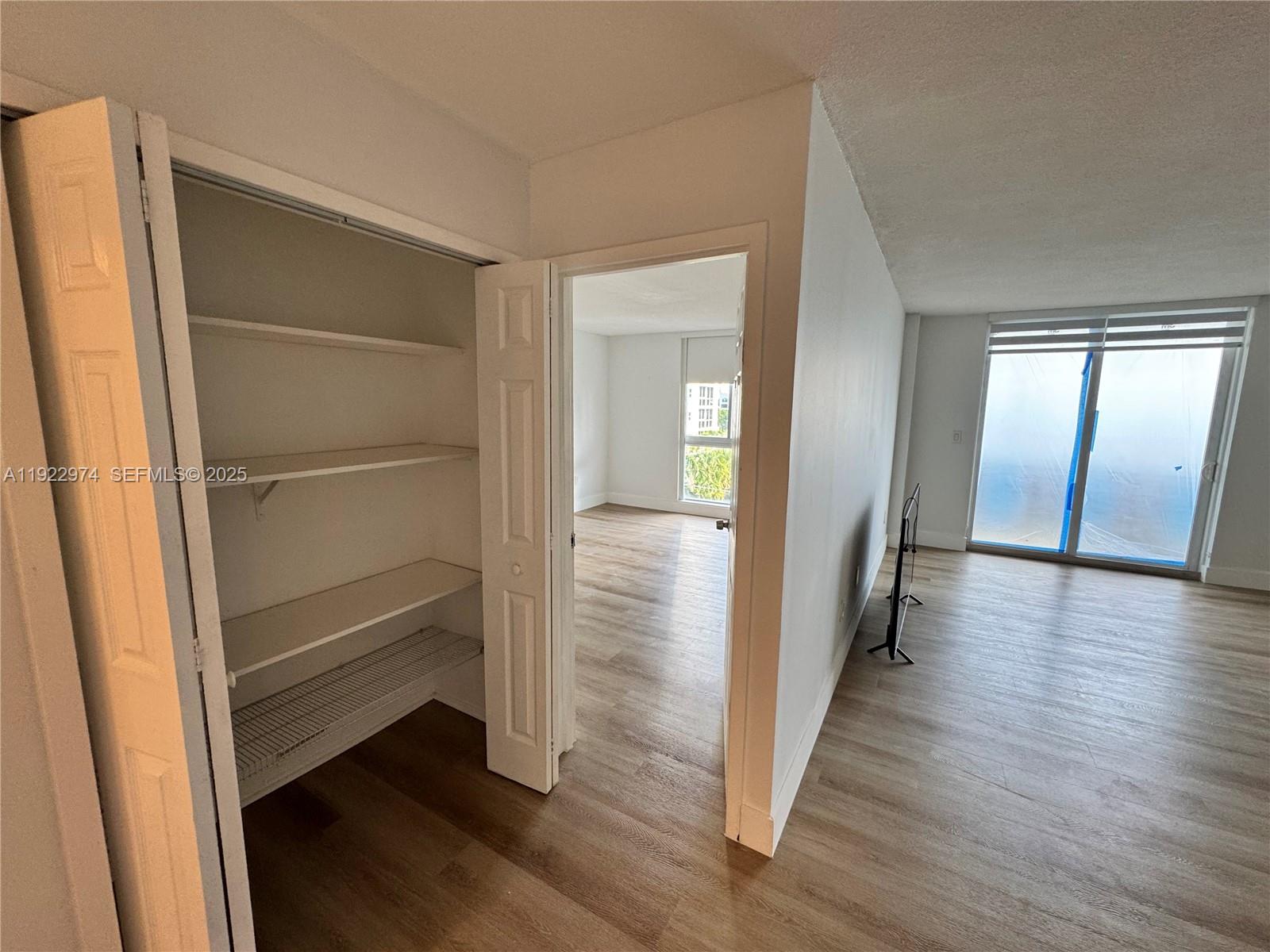 7928 West Drive, Unit 602 North Bay Village, FL 33141 - Photo 9 of 44 a view of a room with wooden floor