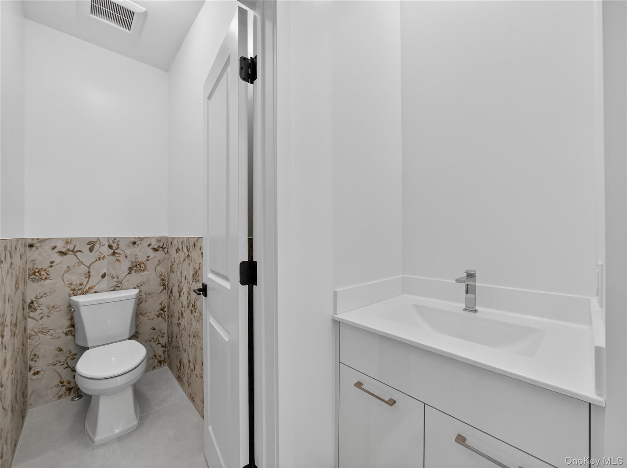 22 Johnson Street Spring Valley, NY 10977 - Photo 21 of 50 a bathroom with a toilet sink and mirror