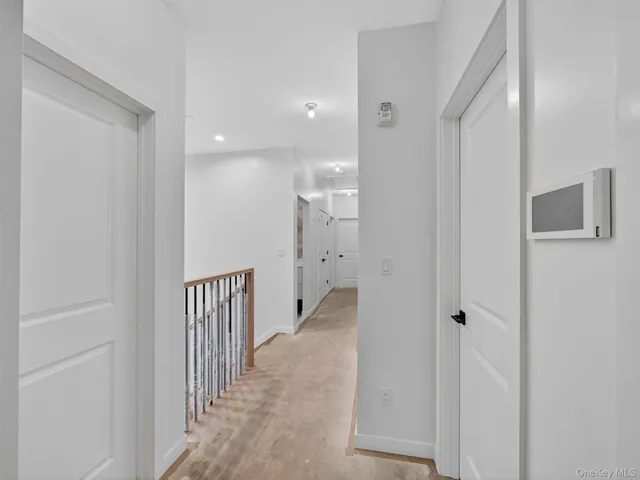 a view of a hallway with white walls