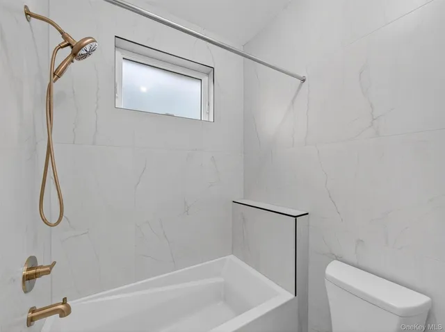 a bathroom with a shower and a toilet