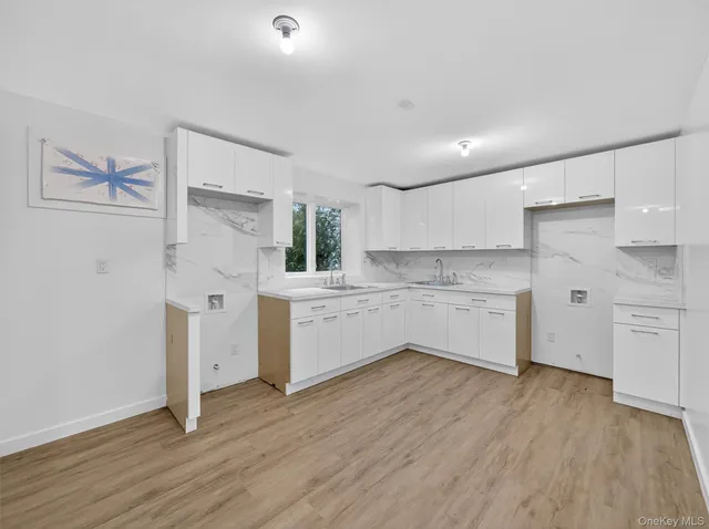 a kitchen with white cabinets and white appliances