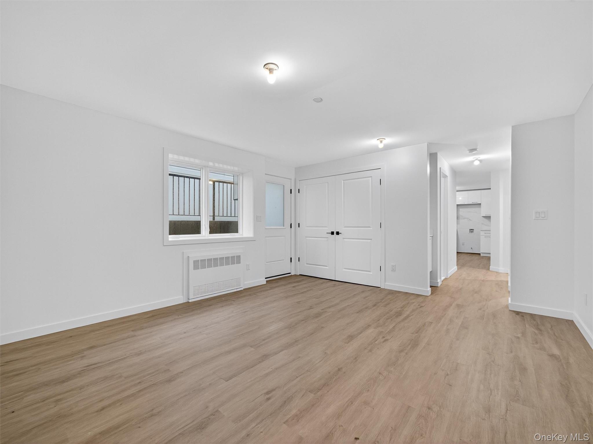 22 Johnson Street Spring Valley, NY 10977 - Photo 48 of 50 an empty room with wooden floor and windows