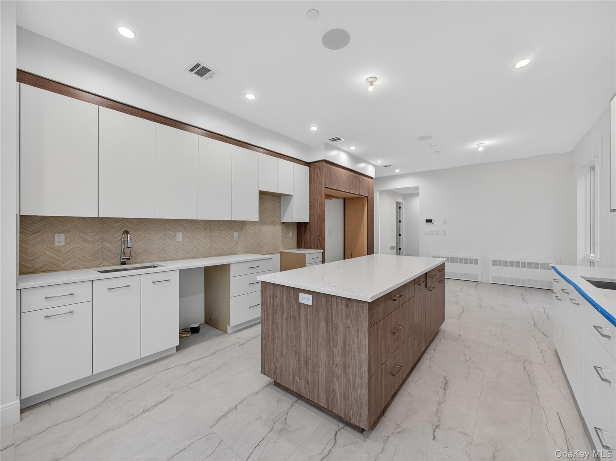 22 Johnson Street Spring Valley, NY 10977 - Photo 5 of 50 a kitchen with white cabinets appliances and a sink