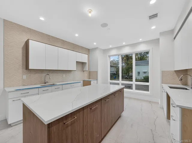 a kitchen with a sink window and cabinets