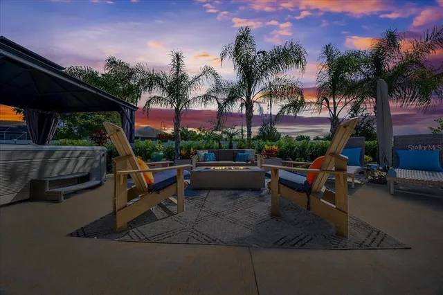 a view of a dining room with furniture and a chandelier