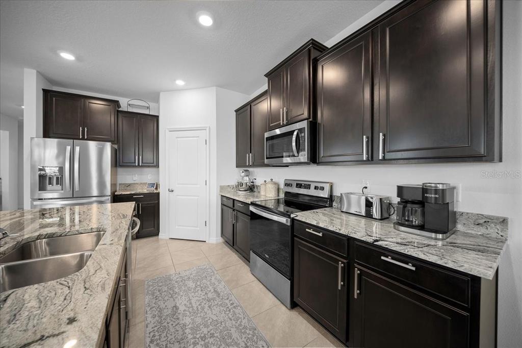 8598 Southwest 59th Terrace Ocala, FL 34476 - Photo 23 of 73 a kitchen with granite countertop stainless steel appliances and sink