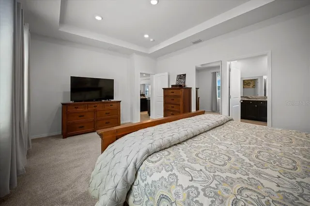 a spacious bathroom with a toilet sink and mirror