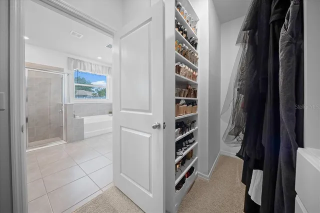 a view of a patio with couches and table and chairs and potted plants