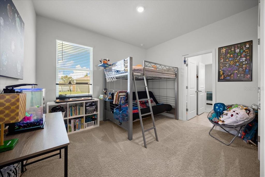 8598 Southwest 59th Terrace Ocala, FL 34476 - Photo 44 of 73 a bedroom with furniture and a window