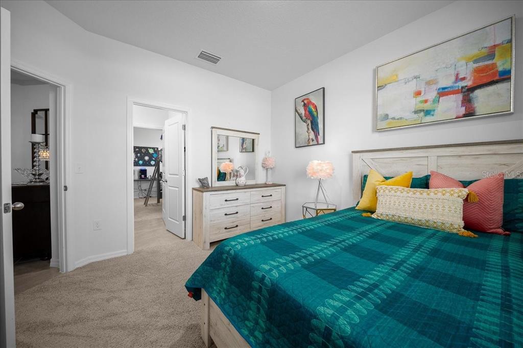 8598 Southwest 59th Terrace Ocala, FL 34476 - Photo 48 of 73 a bedroom with a bed and wall painting