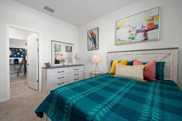 an aerial view of a house with a garden and lake view