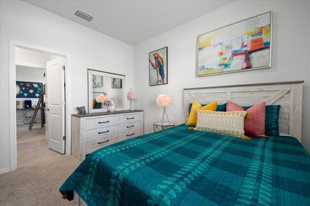 8598 Southwest 59th Terrace Ocala, FL 34476 - Photo 49 of 73 a bedroom with a bed and a view of kitchen