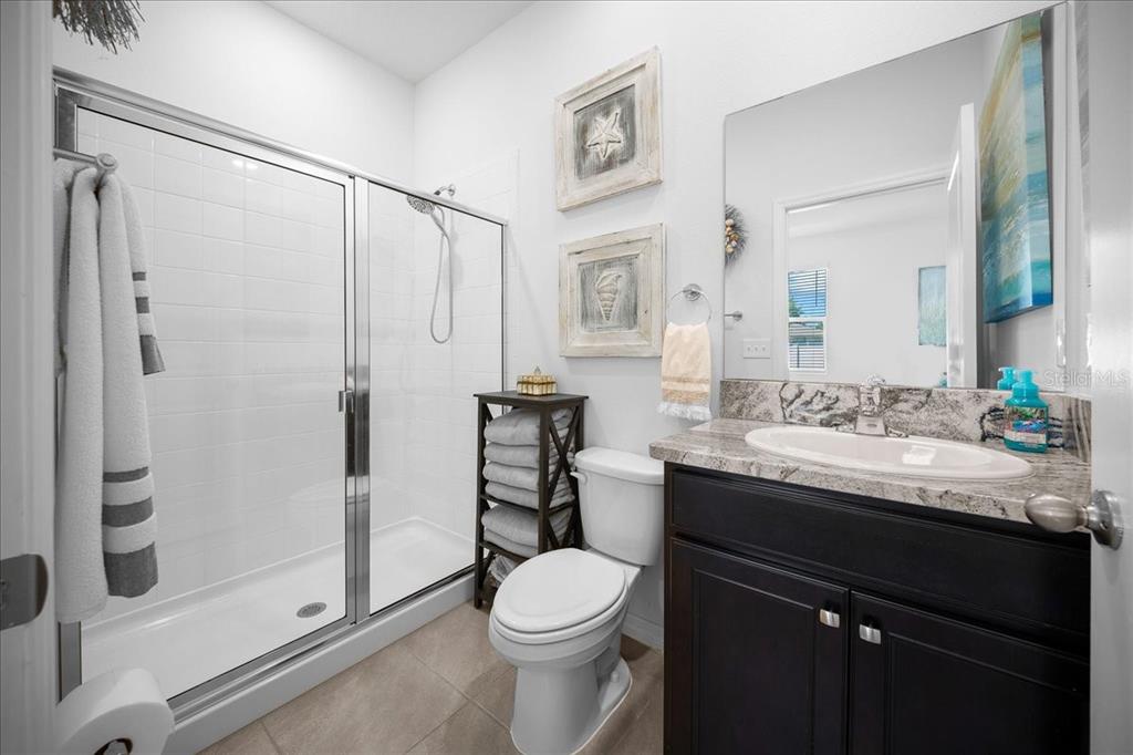 8598 Southwest 59th Terrace Ocala, FL 34476 - Photo 53 of 73 a bathroom with a granite countertop sink toilet and shower