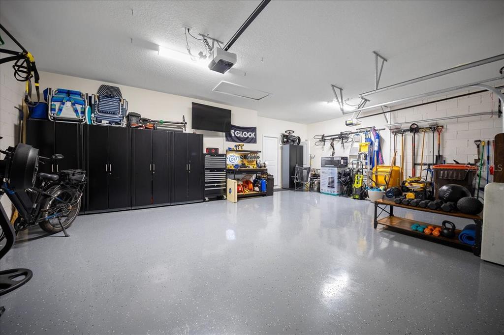 8598 Southwest 59th Terrace Ocala, FL 34476 - Photo 58 of 73 a living room with lots of furniture and gym equipment