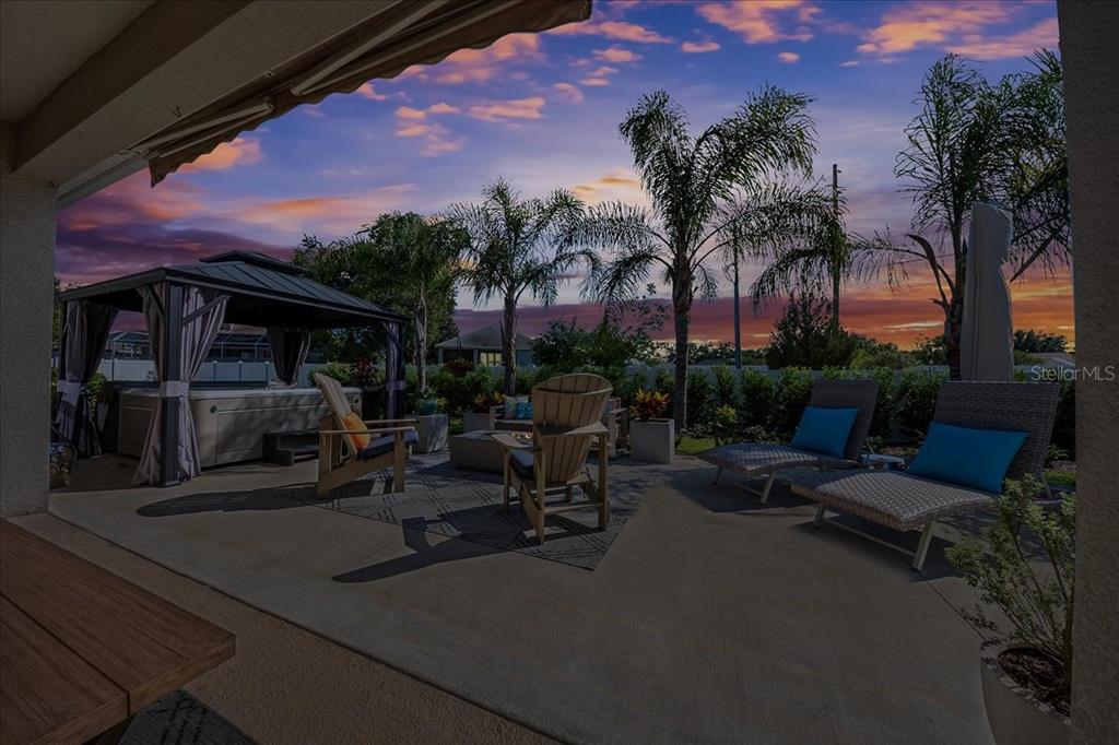 8598 Southwest 59th Terrace Ocala, FL 34476 - Photo 63 of 73 a view of a patio with couches and table and chairs and potted plants