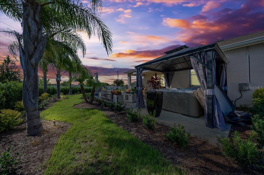 8598 Southwest 59th Terrace Ocala, FL 34476 - Photo 64 of 73 a view of a backyard with couches under an umbrella