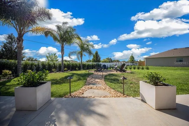 a front view of a house with garden and sitting area