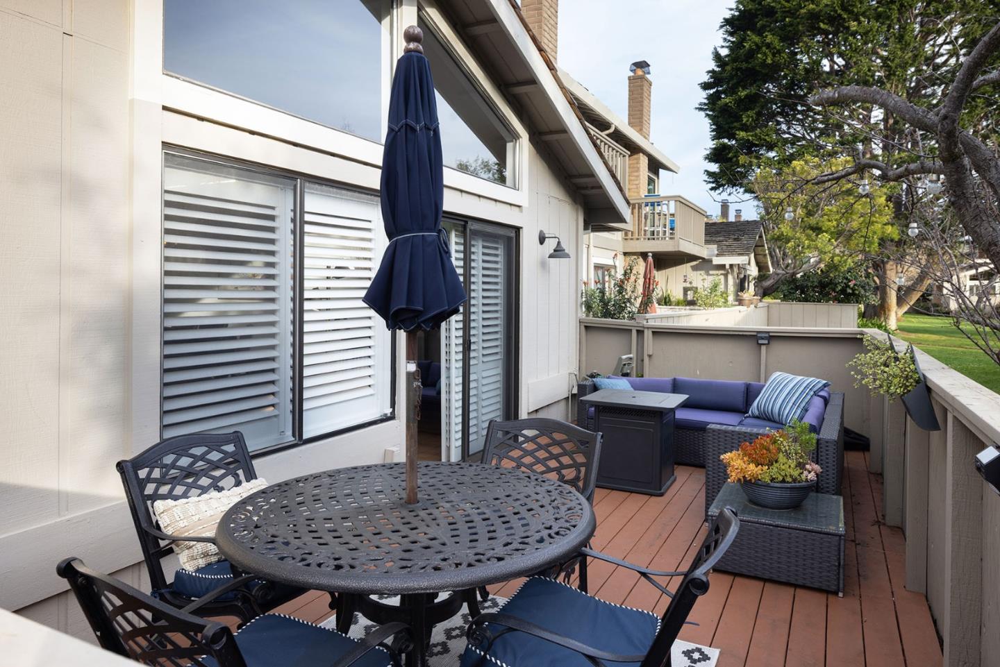 3850 Rio Road, Unit 63 Carmel, CA 93923 - Photo 7 of 19 a outdoor dining space with furniture and wooden floor