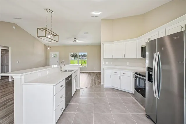 a kitchen with a sink stove and refrigerator