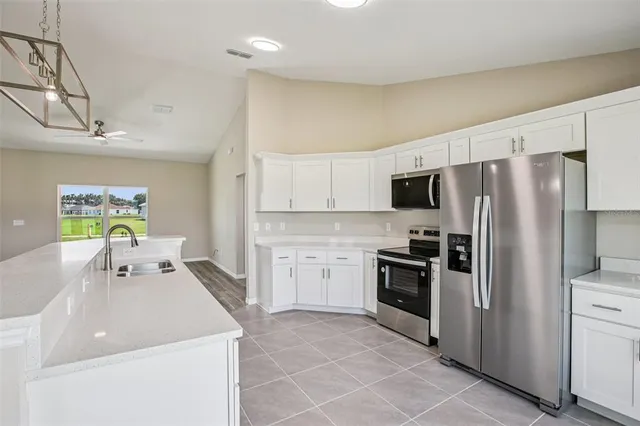 a kitchen with a sink appliances and cabinets