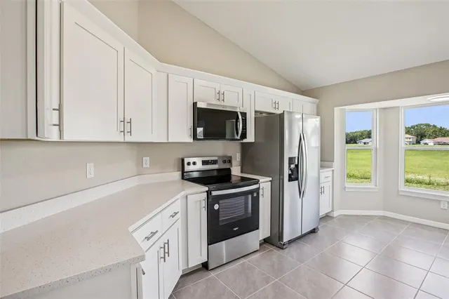 a kitchen with stainless steel appliances a stove sink and refrigerator