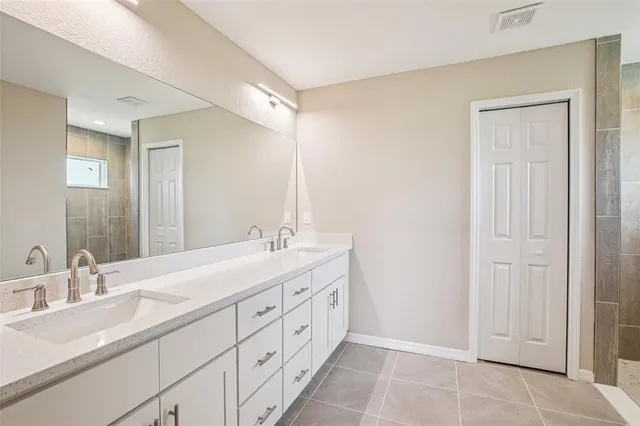 a bathroom with a double vanity sink and a mirror