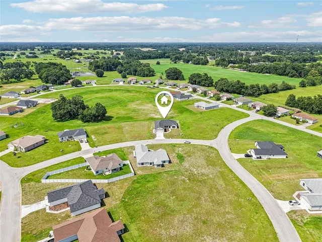 an aerial view of a play house with a yard