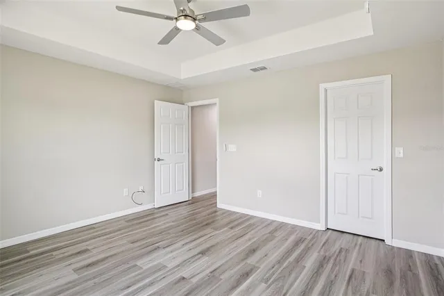 a view of an empty room and wooden floor