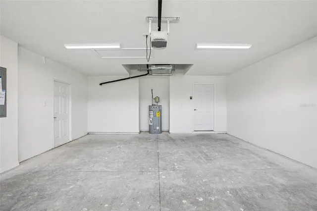 an empty room with a ceiling fan and a window