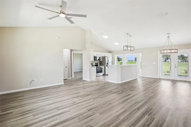 a view of a kitchen with wooden floor and a kitchen space