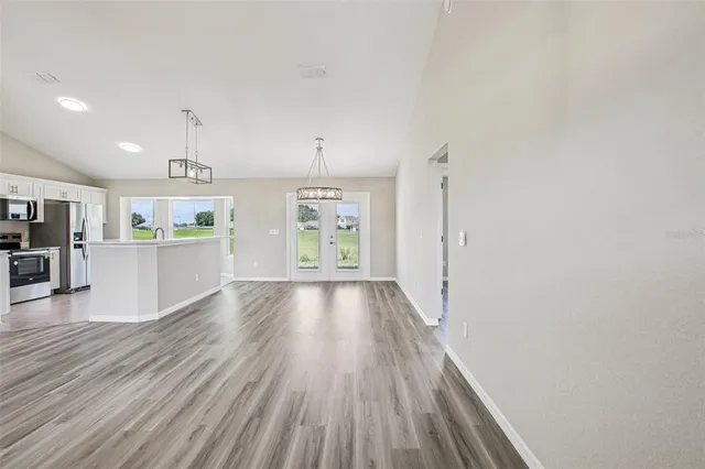a view of a kitchen with wooden floor and a kitchen