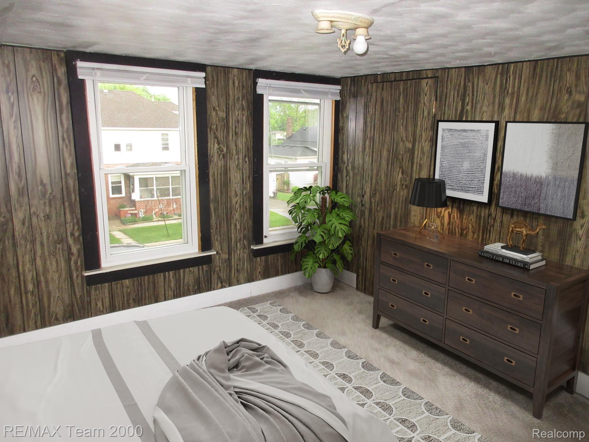 604 Smith Street Monroe, MI 48161 - Photo 9 of 24 Wood-paneled wall with dark trim framing two windows