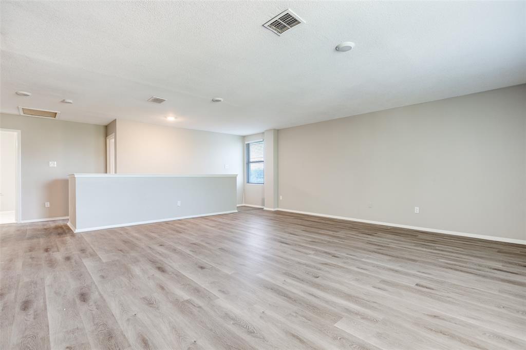 2624 Misty Harbor Drive Little Elm, TX 75068 - Photo 14 of 25 a view of an empty room with wooden floor