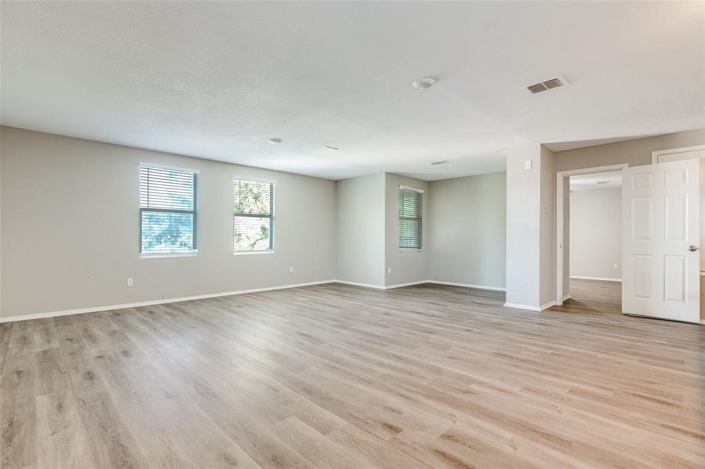 2624 Misty Harbor Drive Little Elm, TX 75068 - Photo 15 of 25 an empty room with wooden floor and windows