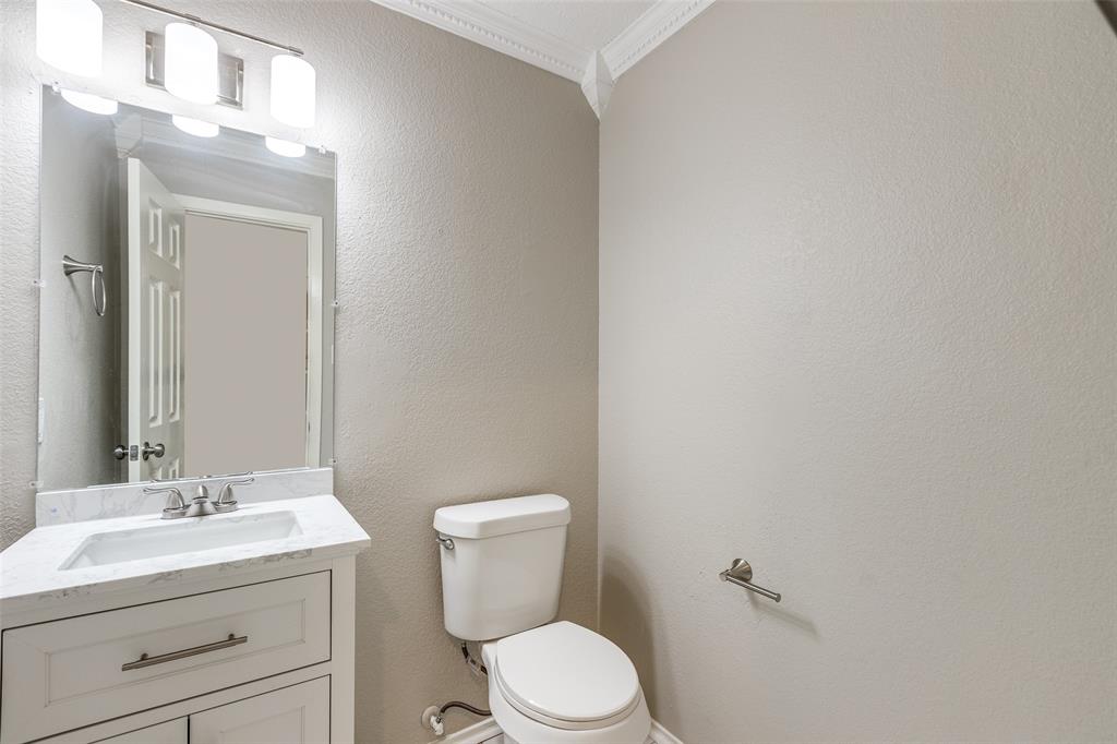 2624 Misty Harbor Drive Little Elm, TX 75068 - Photo 16 of 25 a bathroom with a toilet a sink a mirror and vanity