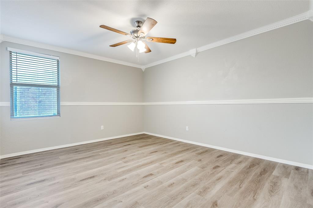 2624 Misty Harbor Drive Little Elm, TX 75068 - Photo 19 of 25 an empty room with wooden floor and windows