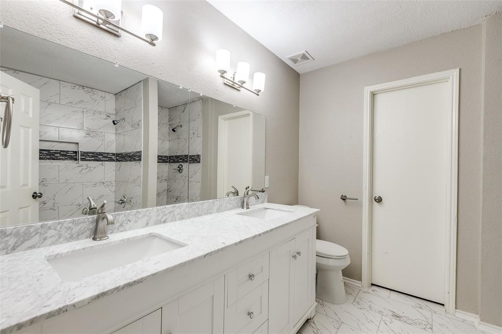 2624 Misty Harbor Drive Little Elm, TX 75068 - Photo 21 of 25 a bathroom with a double vanity sink mirror and toilet